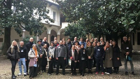 The group of educators that gathered in the historic courtyard of the university